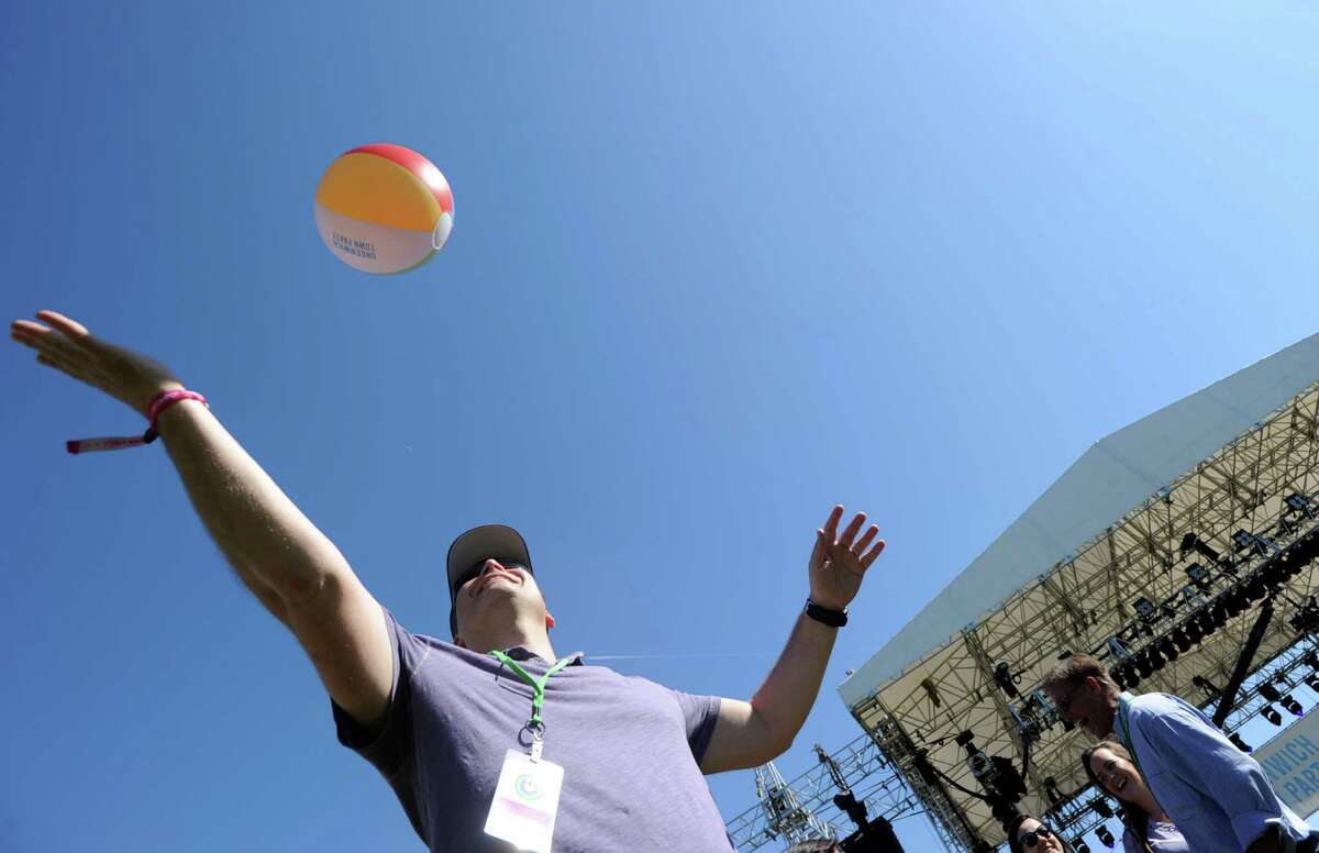 Larchmont, N.Y., resident, Peter Mundheim, left, and his son, Connor, 9, play with a beach-ball durng the Greenwich Town Party at Roger Sherman Baldwin Park, Greenwich, Conn., Saturday, May 23, 2015.