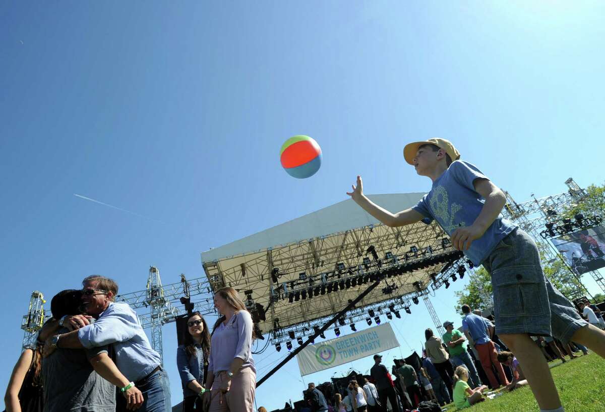 Larchmont, N.Y., resident, Peter Mundheim, left, and his son, Connor, 9, play with a beach-ball durng the Greenwich Town Party at Roger Sherman Baldwin Park, Greenwich, Conn., Saturday, May 23, 2015.