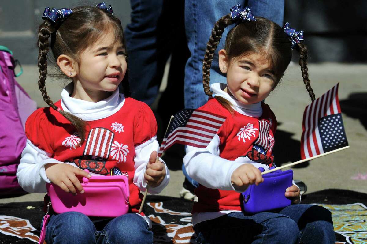 Anabelle Perez, 3, left, and her twin sister Ava Perez, 3, of Ballston Spa wave flags during the Ballston Spa Memorial Day Parade on Saturday, May 23, 2015, in Ballston Spa, N.Y. (Cindy Schultz / Times Union)