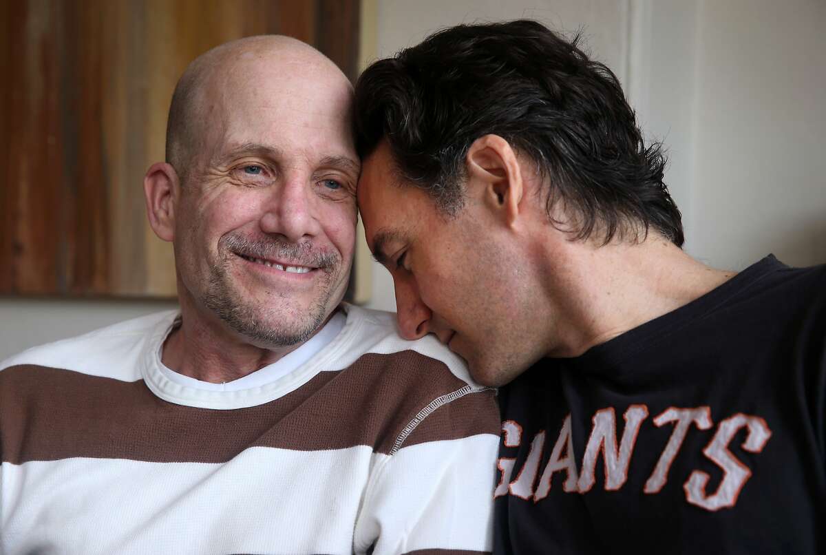 Nick Grillo (left) is seen with his husband and caregiver Kirk Mills at their Mission District apartment in San Francisco, Calif. on Saturday, May 23, 2015. Grillo, who has late-stage ALS, is strongly in favor of two legislative bills that, if passed, would give terminally ill patients the right to try experimental medications before they are approved by the FDA.