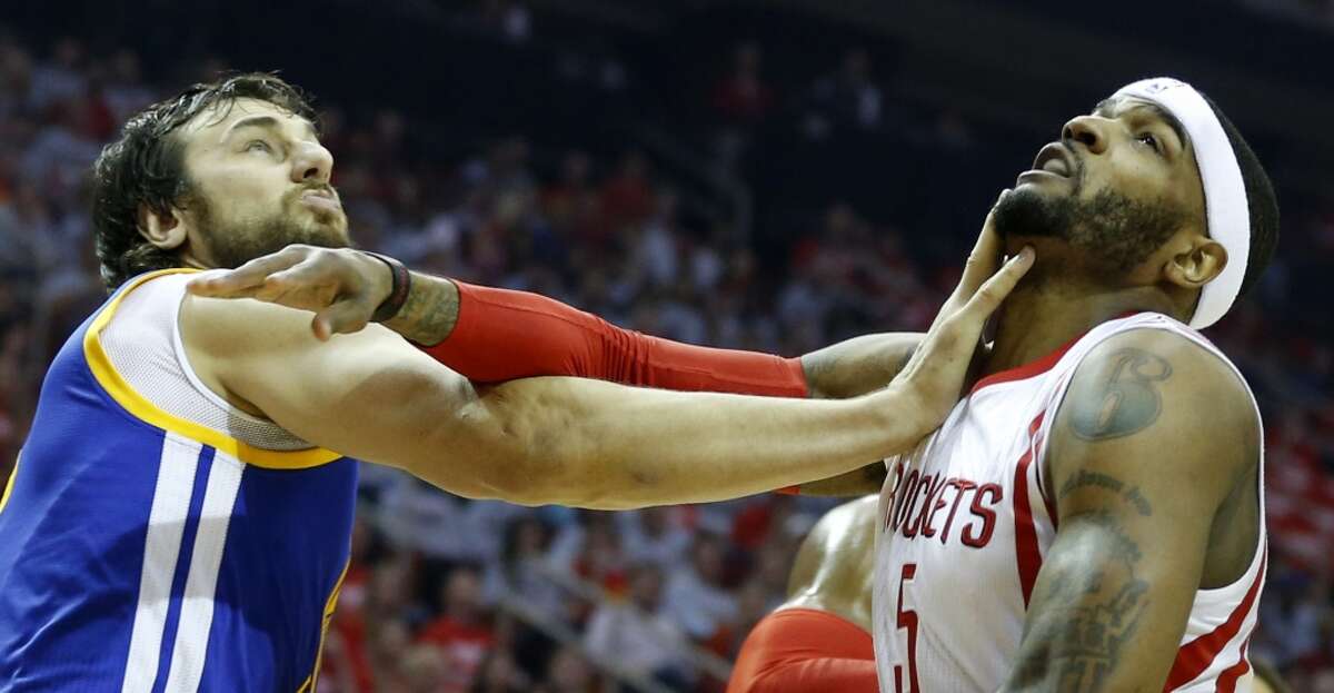 Golden State Warriors center Andrew Bogut (12) and Houston Rockets forward Josh Smith (5) get tangled up under the basket during the first quarter of Game 3 of the NBA Western Conference finals at the Toyota Center on Saturday, May 23, 2015, in Houston. ( James Nielsen / Houston Chronicle )