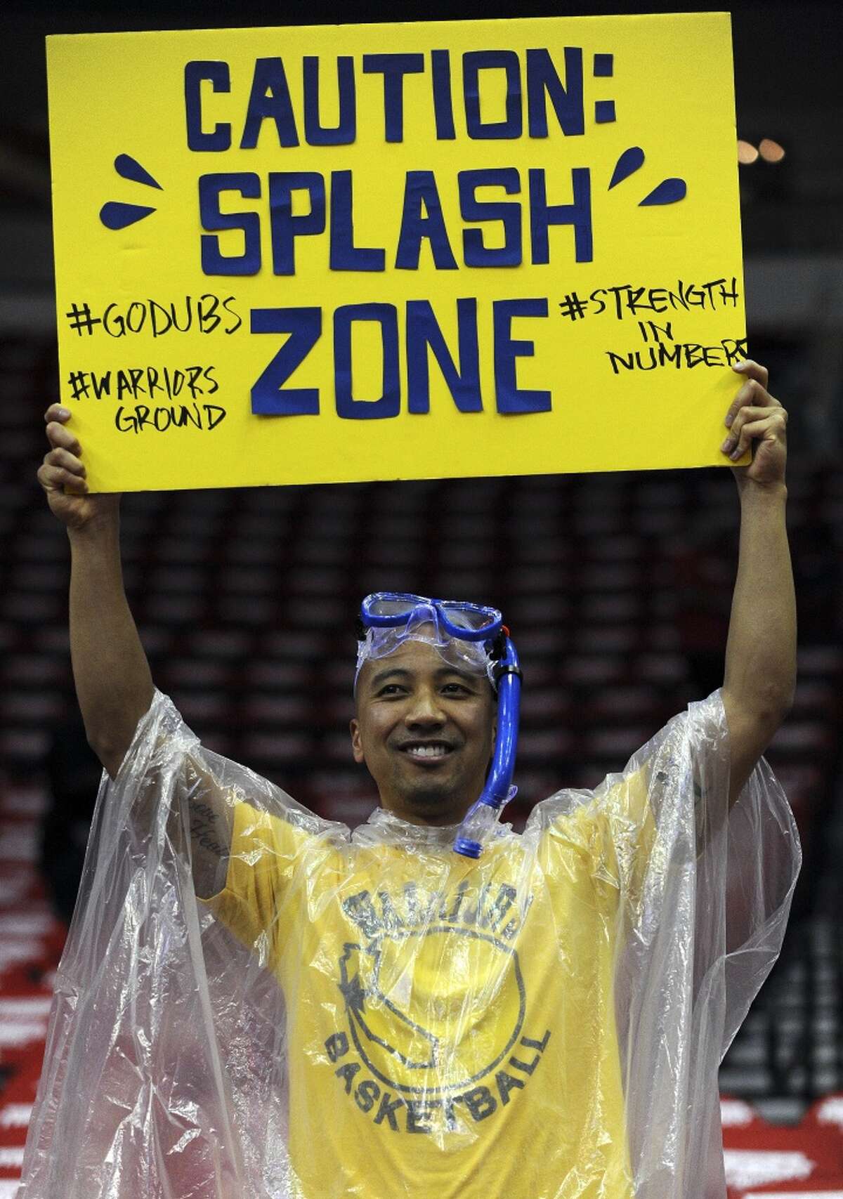 Golden State Warriors fan Angelo Macugay of San Francisco, CA. displays a sign supporting Golden State Warriors guard Stephen Curry #30 and Golden State Warriors guard Klay Thompson #11before Game 3 of the Western Conference Finals against the Houston Rockets, Saturday, May 23, 2015, at Toyota Center in Houston, TX. (Photo: Eric Christian Smith/Special to the Chronicle)