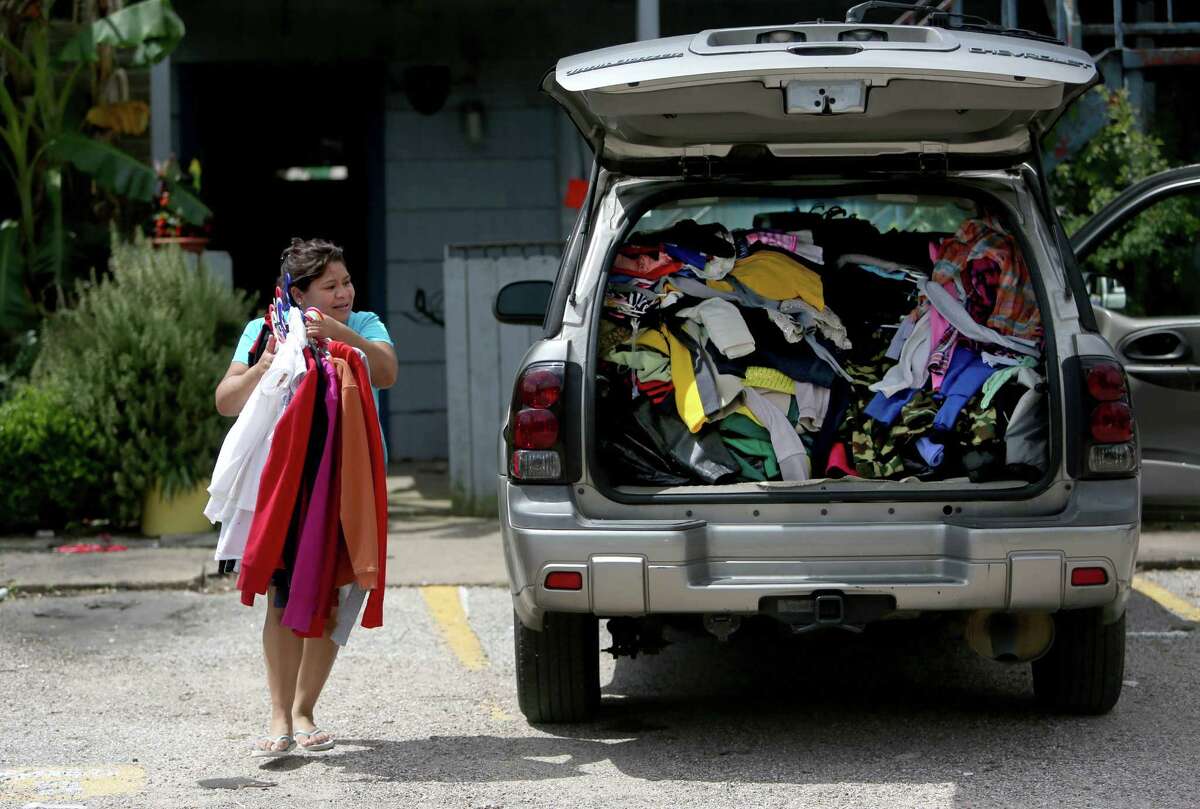 Adela Dominguez removes ﻿clothes from her condemned apartment where she lived with her husband and daughter﻿.