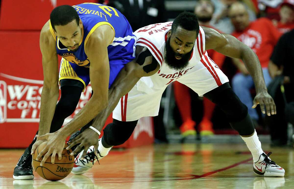 Golden State Warriors guard Shaun Livingston (34) and Houston Rockets guard James Harden (13) fight for a loose ball during the second quarter of Game 4 of the NBA Western Conference finals at the Toyota Center on Monday, May 25, 2015, in Houston. ( James Nielsen / Houston Chronicle )