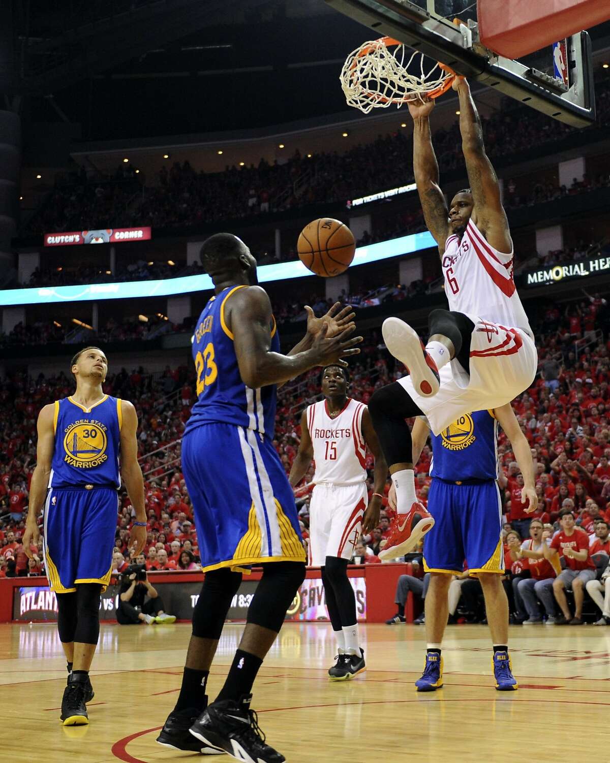 Houston Rockets forward Terrence Jones #6 slam dunks as Golden State Warriors forward Draymond Green #23 looks on in the third quarter of Game 4 of the Western Conference Finals, Monday, May 25, 2015, at Toyota Center in Houston, TX.