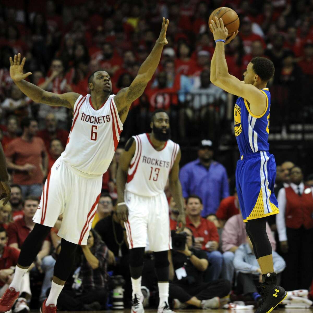 Golden State Warriors guard Stephen Curry #30 shots the ball as Houston Rockets forward Terrence Jones #6 defends in the third quarter of Game 4 of the Western Conference Finals, Monday, May 25, 2015, at Toyota Center in Houston, TX.