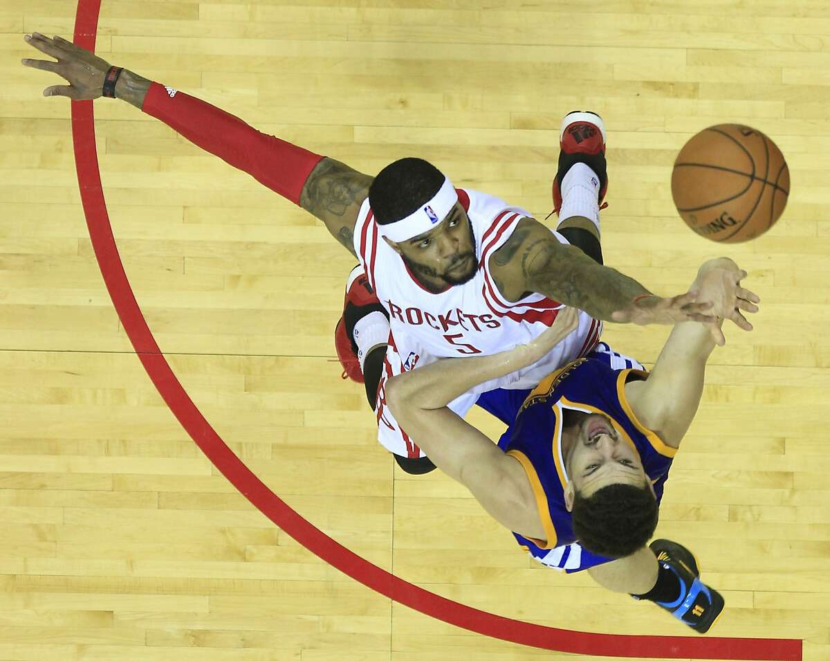 Houston Rockets forward Josh Smith (5) defends a shot by Golden State Warriors guard Klay Thompson (11) during the second half of Game 4 of the NBA Western Conference finals at the Toyota Center on Monday, May 25, 2015, in Houston. ( James Nielsen / Houston Chronicle )