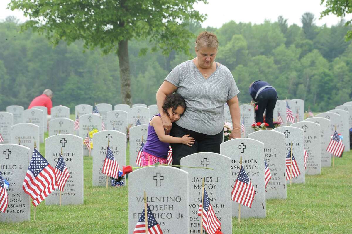 Emma Roth of Clifton Park and her great granddaughter Tatianna Valquez, 4, of Schenectady visit the grave of Emma's husband who served in the Army in Vietnam at the Gerald B. H. Solomon National Cemetery on Monday, May 25, 2015 in Schuylerville, N.Y. The cemetery hosted a Memorial Day event. (Lori Van Buren / Times Union)