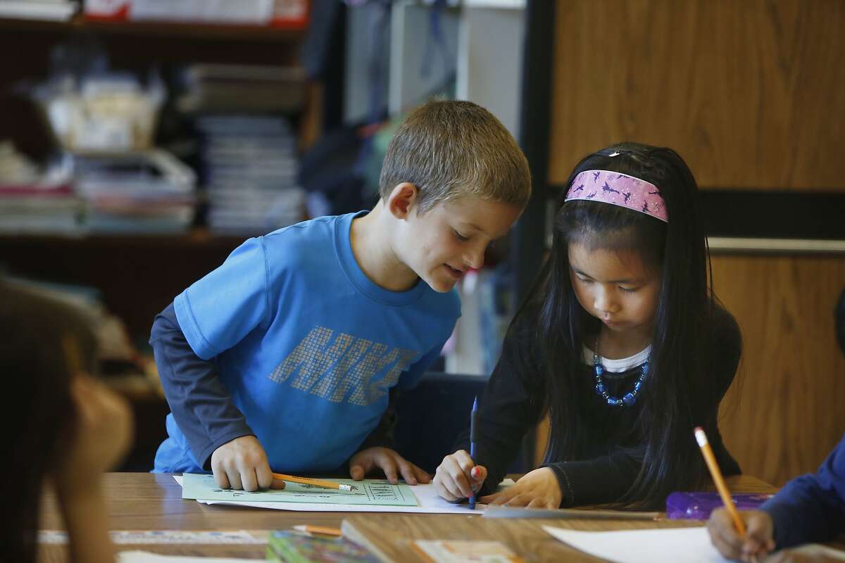 Second graders Maxson Cook (l to r) and Emily Chuong work together to solve a math problem at Argonne Elementary School during a math lesson on Tuesday, May 26, 2015 in San Francisco, Calif.