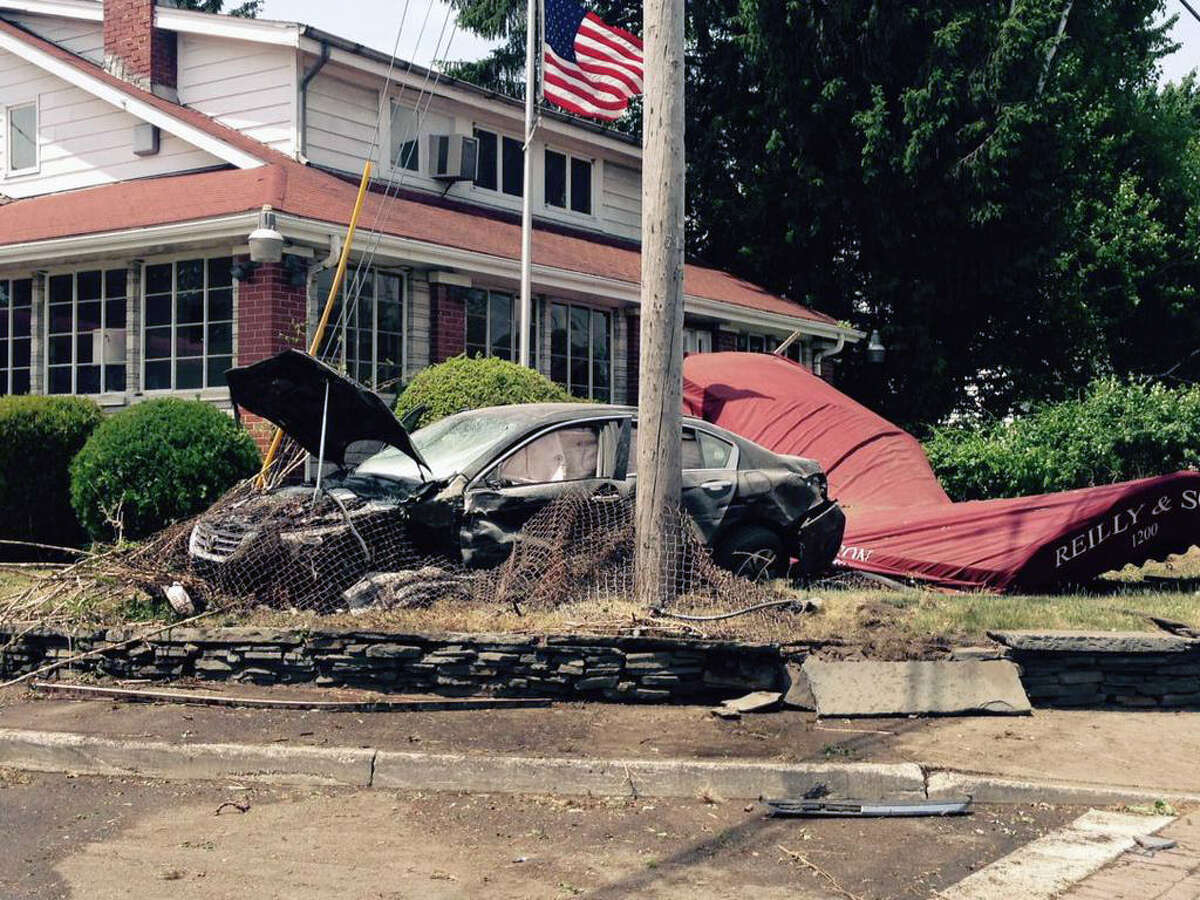 Car crashes into several vehicles, funeral home awning