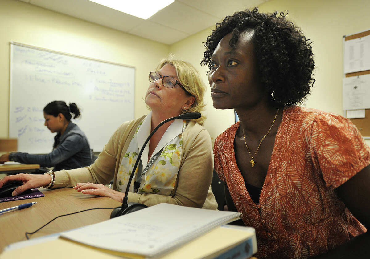 Congolese refugee Elise Biandi, right, works with program facilitator Lynn Davies, of Stratford, on her equivalency diploma in the NEDP lab at the Mercy Learning Center in Bridgeport, Conn. on Tuesday, May 26, 2015. The NEDP, or National External Diploma Program, is a popular new alternative to the traditional GED.