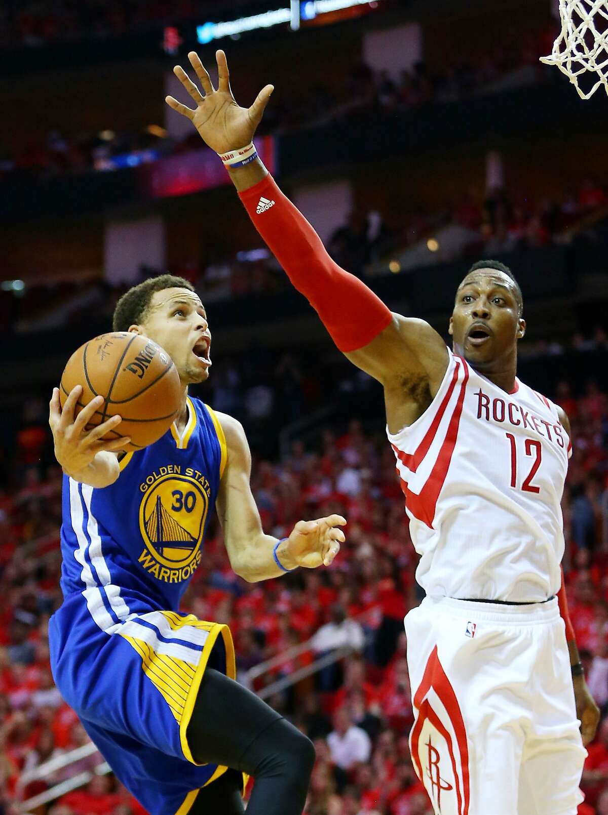 HOUSTON, TX - MAY 25: Stephen Curry #30 of the Golden State Warriors goes up against Dwight Howard #12 of the Houston Rockets in the fourth quarter during Game Four of the Western Conference Finals of the 2015 NBA Playoffs at Toyota Center on May 25, 2015 in Houston, Texas. NOTE TO USER: User expressly acknowledges and agrees that, by downloading and or using this photograph, user is consenting to the terms and conditions of Getty Images License Agreement. (Photo by Ronald Martinez/Getty Images)