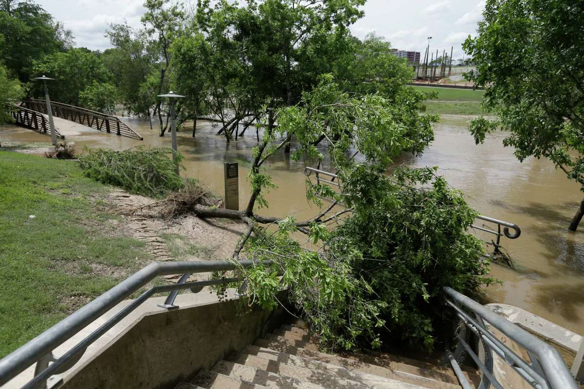 Mud and storm debris cover pathways Wednesday along Buffalo Bayou Park, but storm damage was light. ﻿