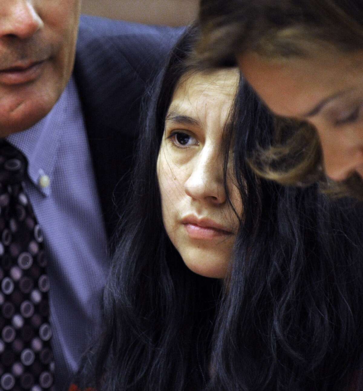Lidia Quilligana, 31, pleaded not guilty Wednesday, April 22, 2015. Quilligana, center, appeared in State Superior Court in Danbury, Conn. and was aided by interpreter Javier Lillo and represented by her attorney Jennifer Tunnard.