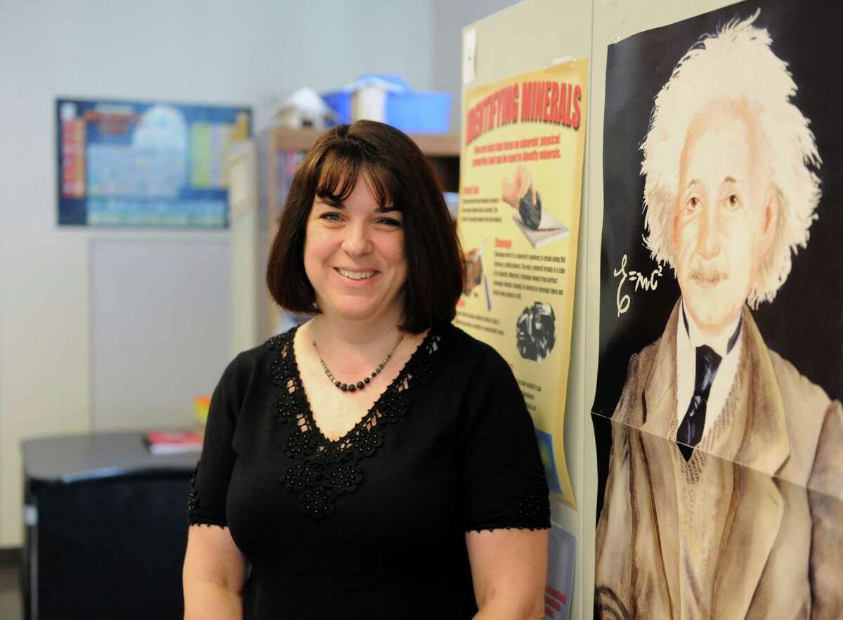 STEM Faculty Coach Cathy Byrne poses next to a poster of Einstein in her office at Hamilton Avenue School in Greenwich, Conn. Thursday, May 28, 2015. Byrne, formerly a fifth-grade teacher, recently took the job of STEM Faculty Coach to help teachers excel in the areas of science, technology, egineering and math education. She was awarded one of the six Greenwich School District Distinguished Teacher Awards for 2015.