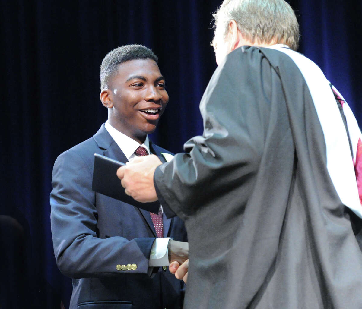 At left, Graduating senior, Michael McKelvie, Jr., receives his dipolma from Paul Geise, head of Stanwich School, during the commencement at the school in Greenwich, Conn., Thursday, May 28, 2015.