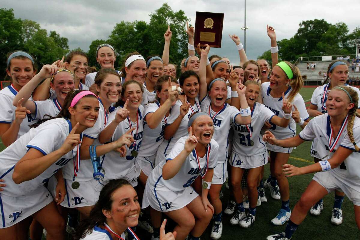 Darien celebrates their 13-12 triple overtime victory over New Cacaan in the FCIAC Girls Lacrosse Championship at Brien McMahon High School in Norwalk, Conn. on Thursday, May 28, 2015.