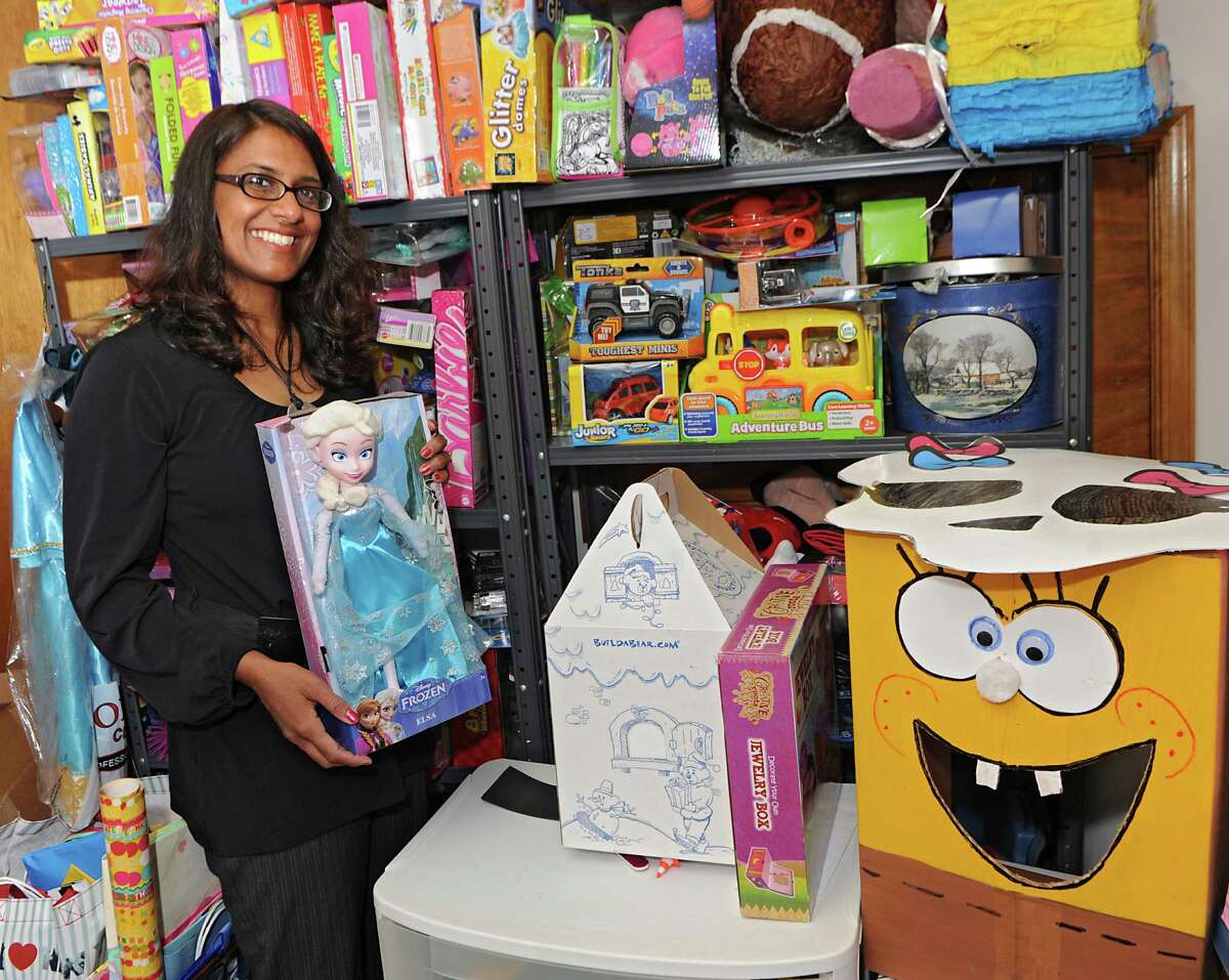 Fazana Saleem-Ismail stands in her basement with some of the donated party supplies she uses to throw birthday parties for homeless children on Wednesday, May 27, 2015 in Schenectady, N.Y. Fazana founded the nonprofit organization Jazzy Sun Birthdays in order to give kids who are living in shelters a sense of normalcy with real birthday parties. This(Lori Van Buren / Times Union)