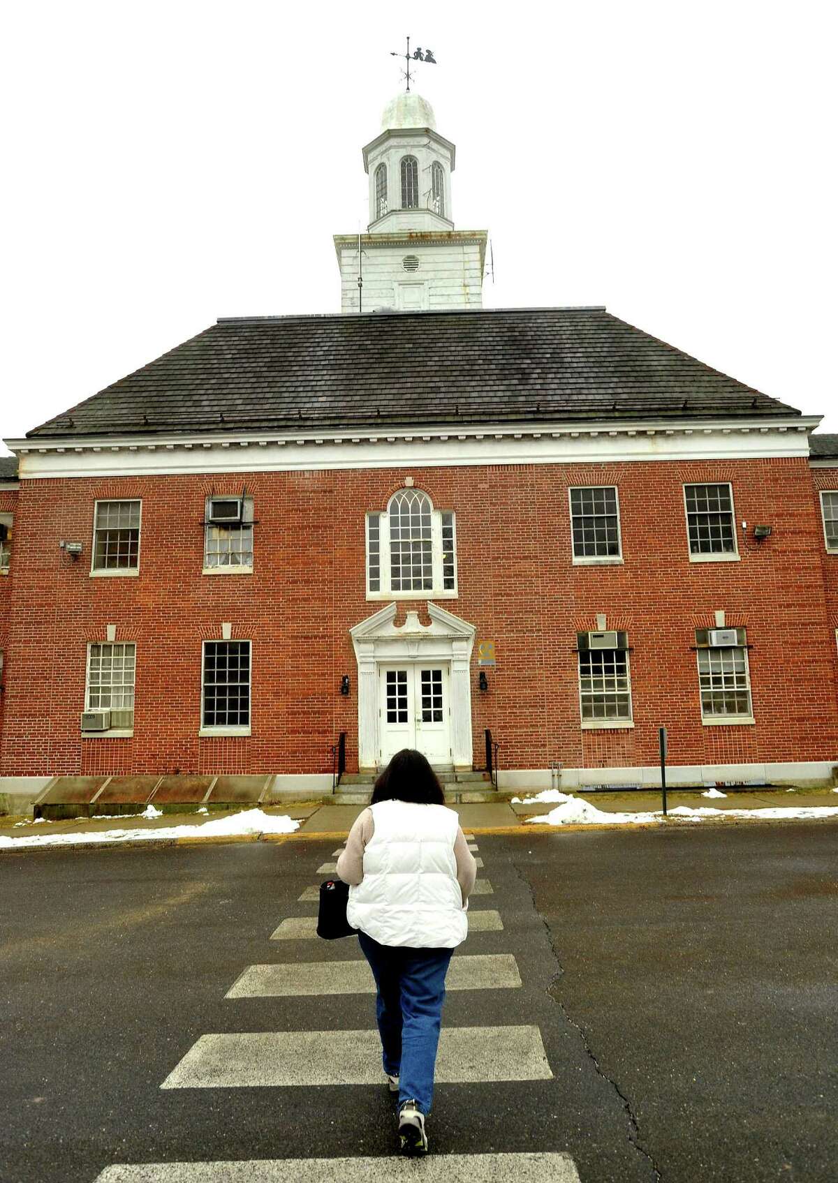 A worker enters the Lenore Davidson Building at Southbury Training School in 2012.