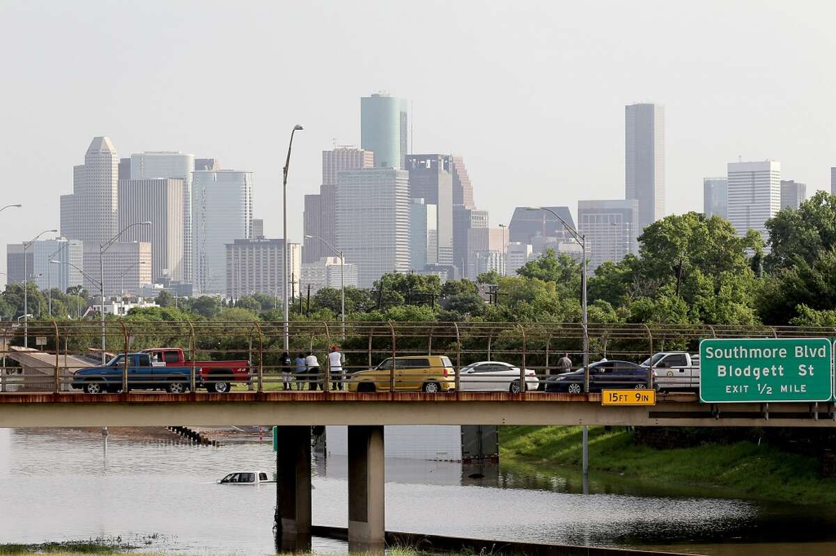 People stop and view the flooded waters on 288 and McGregor in the Medical Center on Tuesday, May 26, 2015 in Houston, TX (Photo: Thomas B. Shea/For the Chronicle)