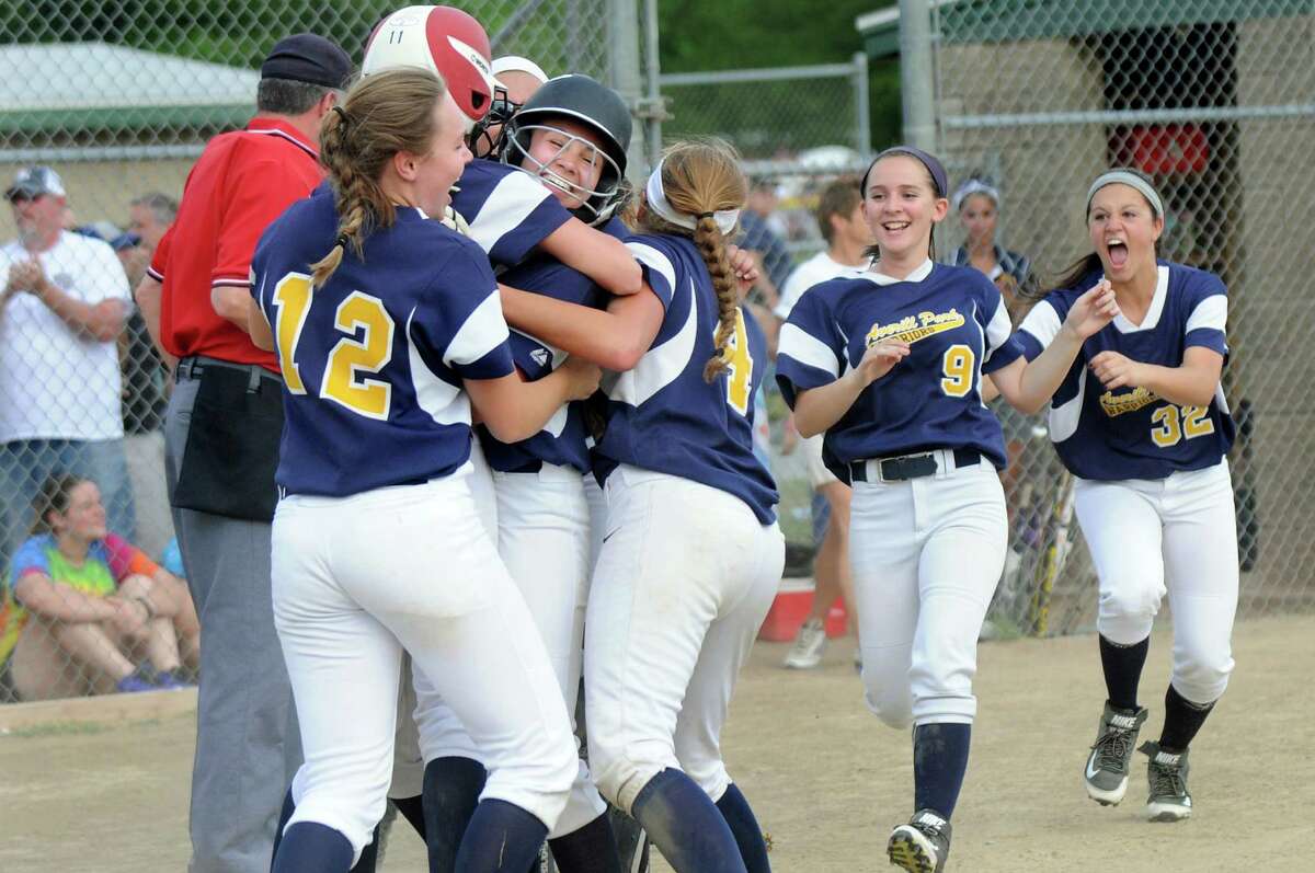 Averill Park's Torey Chenette, center, gets mobbed by her team as they celebrate their dramatic 3-2 win over Troy in the Class A softball final on Friday, May 29, 2015, at Clifton Common in Clifton Park, N.Y. (Cindy Schultz / Times Union)