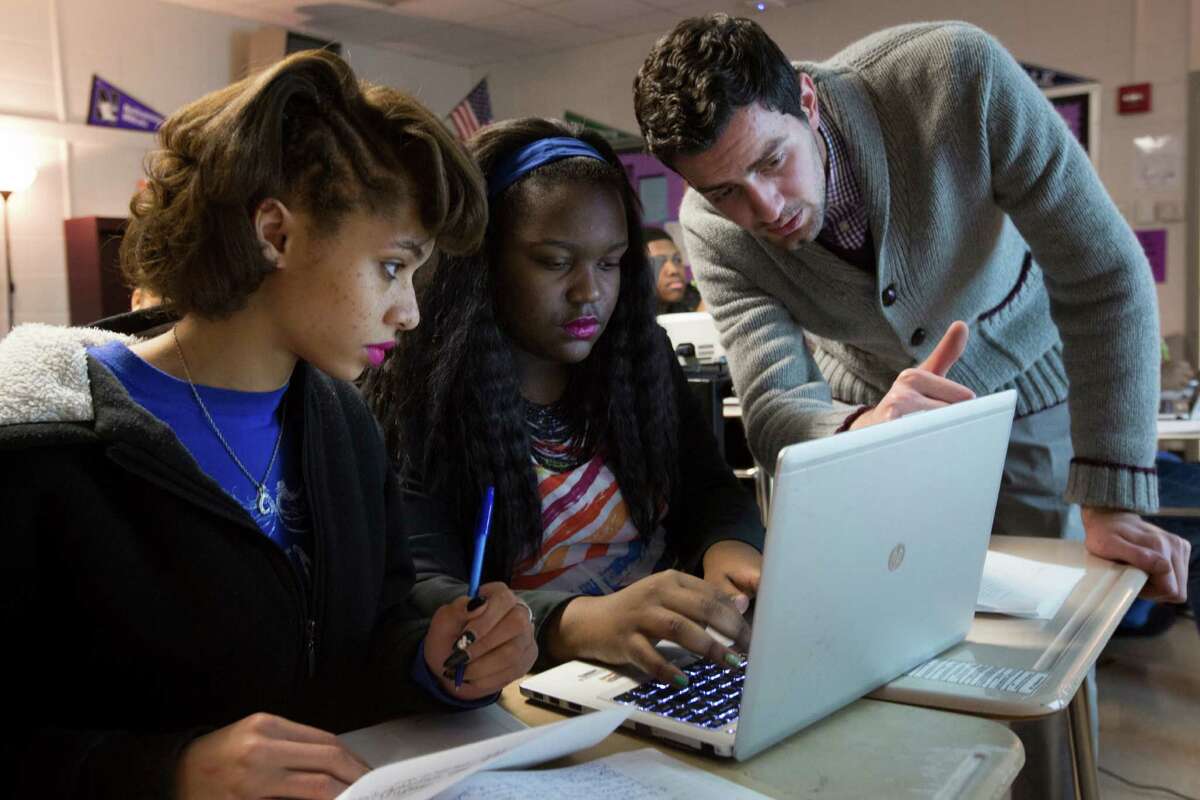 ﻿From left, Cora Desrochers, 18, and Viaginae Edmond, 16, take instruction from Kashmere High School physics teacher Adeeb Barqawi.