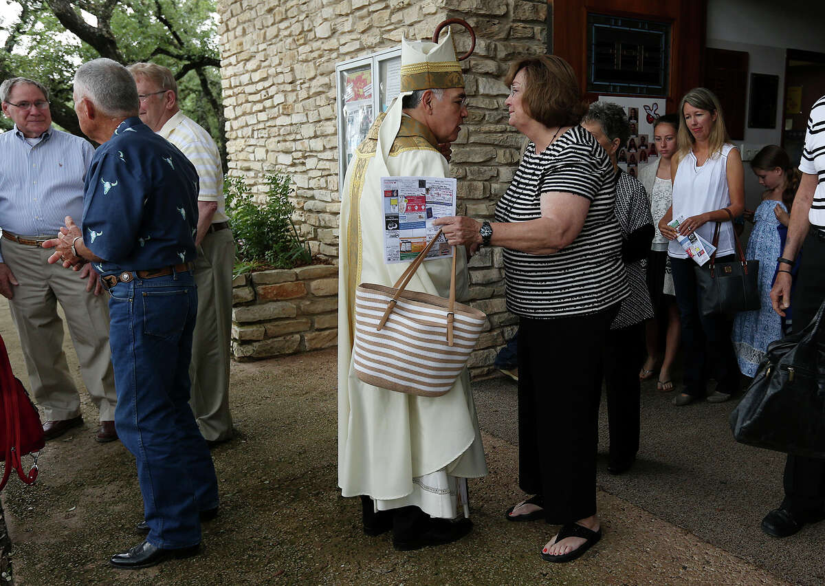 Diocese of Austin Bishop Joe S. Vasquez greets St. Mary's Catholic Church parishioners after a service in Wimberley, Texas, Sunday, May 31, 2015. Also, volunteers search the Blanco River off Red Hawk Road northeast of Wimberley. Vasquez' message on the tragic flood was, "Turn to God at this moment. This is a time when we all have to face the reality of the loss of loved ones, the loss of property, the loss of people who are close to us. We're family, we have to take care of one another".