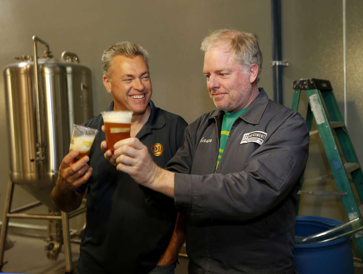 Owners Nico Freccia (left) and Shaun O'Sullivan enjoy a little of the first IPA brewed at the new facility Monday June 1, 2015. 21st Amendment Brewery is opening a massive and ambitious multi-million dollar facility in San Leandro, Calif. at the site of the former Kellog Cereal factory.