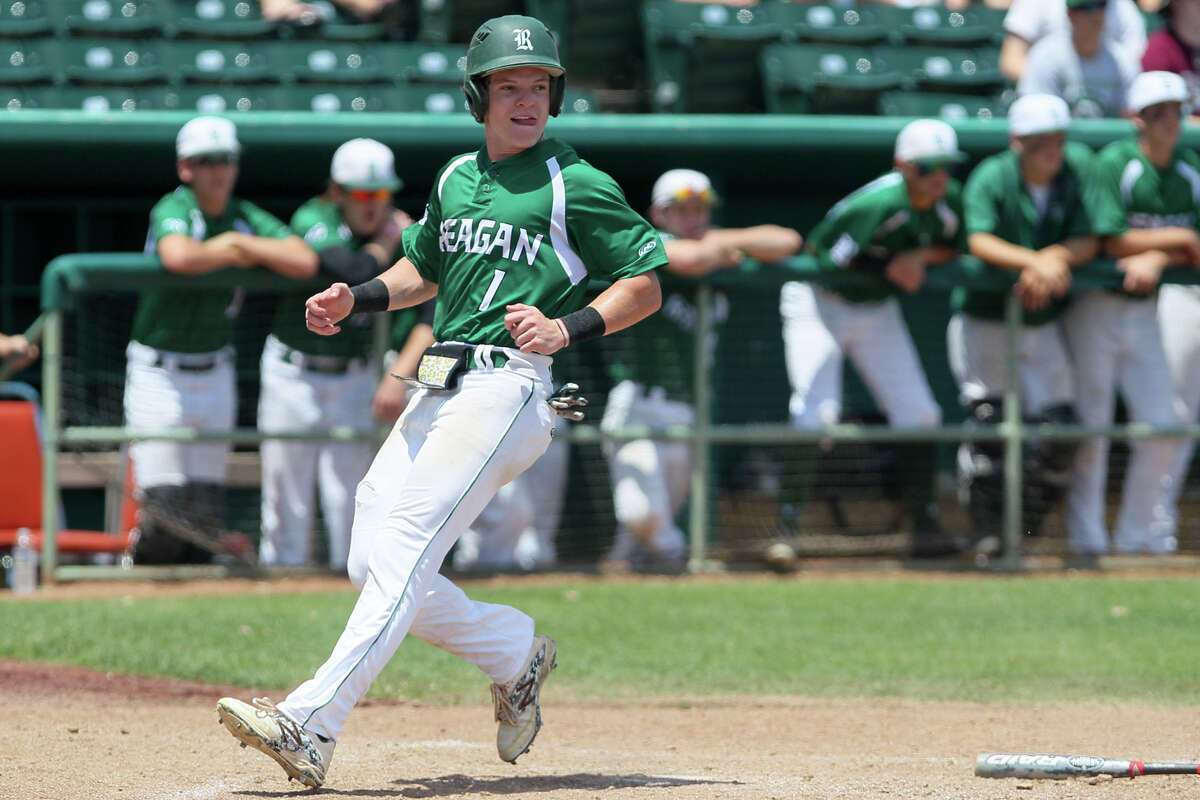 Reagan’s Connor Heffron scores a run in the fifth inning during Game 2 of their 6A fourth-round series with Laredo Alexander at Wolff Stadium on June 1, 2015.