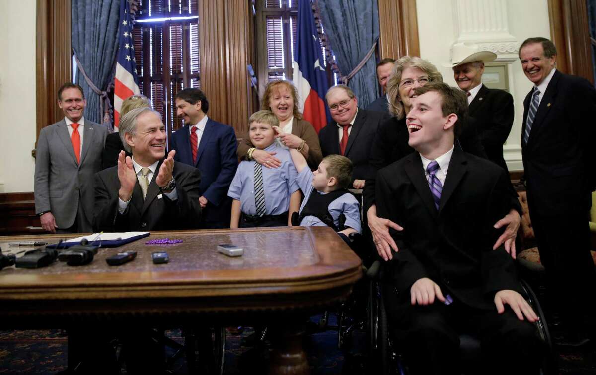 Zachariah Moccia (front right), a 25-year-old who has Dravet syndrome, a rare, genetic form of epilepsy, celebrates after Gov. Greg Abbott signed Senate Bill 339 into law. The new law allows the medical use of low-THC cannabidiol, or CBD oil.