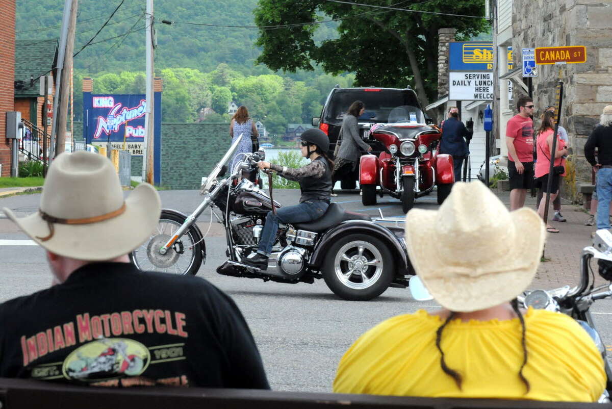 Ronald and Lynne Colby of East Hampton, Mass. watch the passing traffic as motorcycles fill the streets for the 2014 Americade on Thursday June 5, 2014 in Lake George, N.Y. 