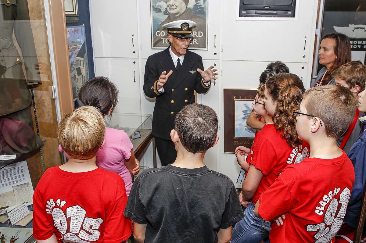 Commemorative Air Force Museum Curator Sam Hoynes talks with students from Katy Elementary about WWII planes and pilots at the Commemorative Air Force's Hanger located at West Houston Airport on May 22, 2015.