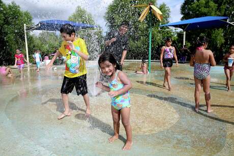 Kids plays at the Splash Pad at Centennial Park in Pearland.