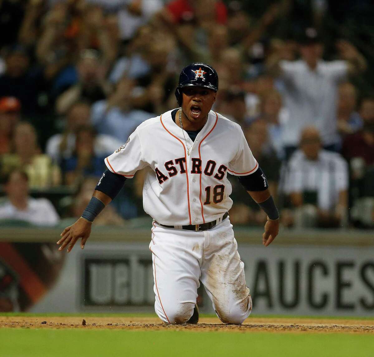 Astros third baseman Luis Valbuena was dishing out and taking punishment Tuesday night. He homered in the third, needed attention from trainer Nate Lucero, left, after being hit by a pitch in the fifth, and let loose after scoring an insurance run in the eighth, right.