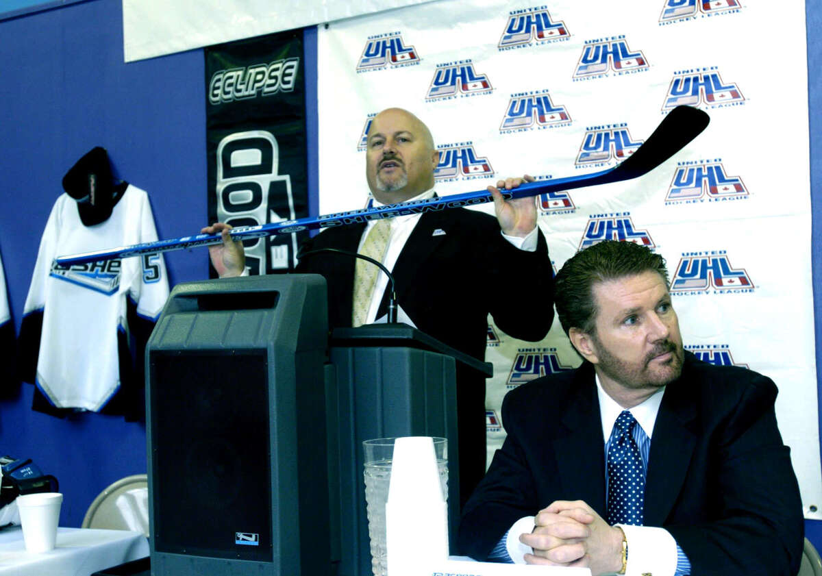 In this file photo, UHL (United Hockey League) president Richard Brosal holds a hockey stick during a press conference announcing the coming of professional hockey to Danbury. The Danbury Trashers owner James Galante is right.