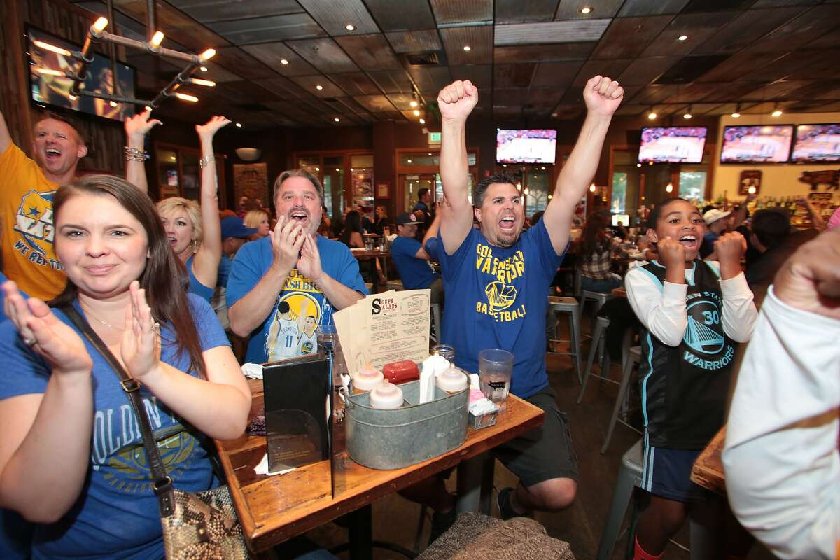 Fans react to Game 4 of the NBA playoffs during a watch party at Sauced BBQ & Spirits on May 25, 2015.