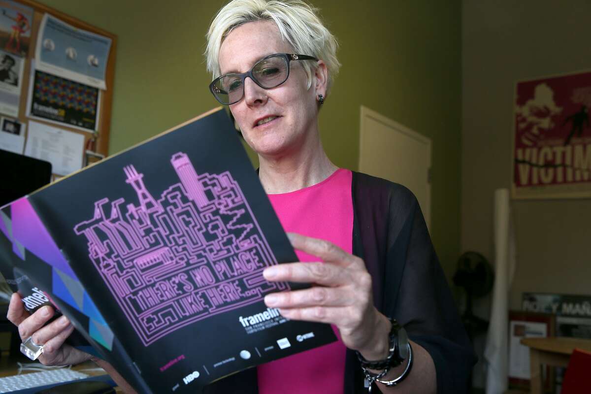 Frances Wallace, the new executive director of the Frameline film festival, flips through a program for this year's event in San Francisco, Calif. on Wednesday, June 3, 2015. The Frameline39 LGBTQ film festival opens June 18 and concludes June 28.