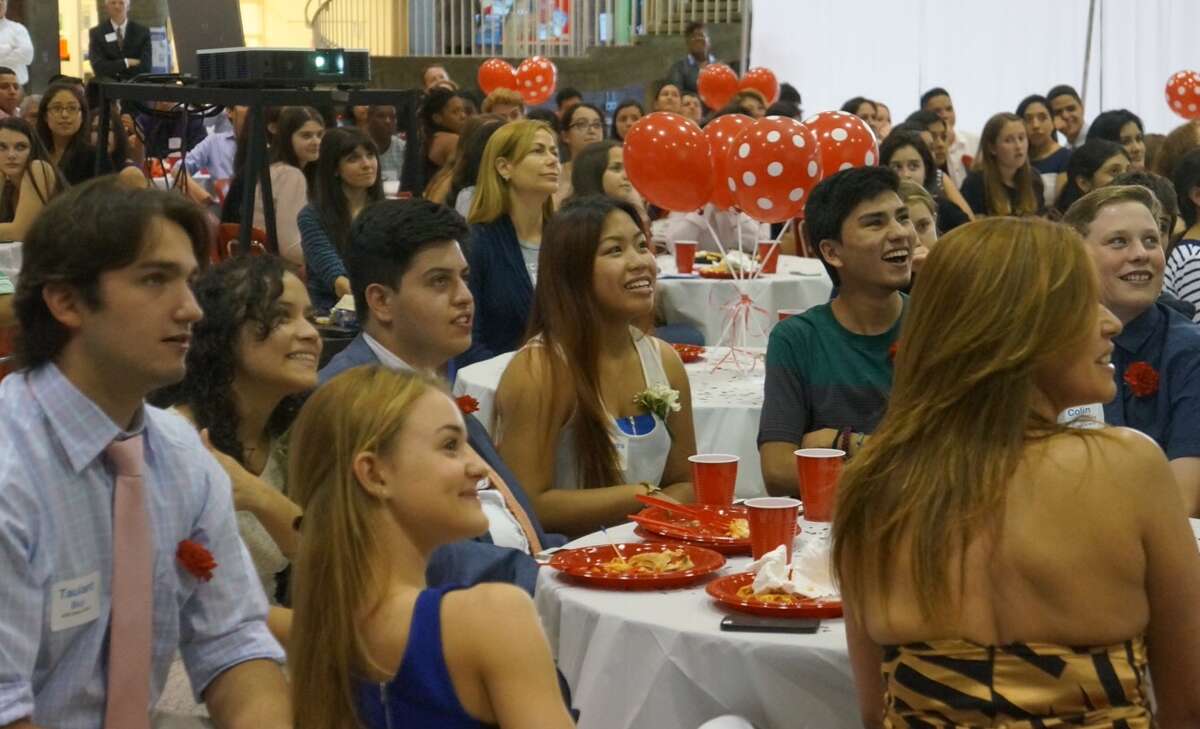 Greenwich High seniors in the AVID class of 2015 watch a slideshow of their time at the high school, during the recognition ceremony in the Greenwich High student center on Wednesday, June 3, 2015.
