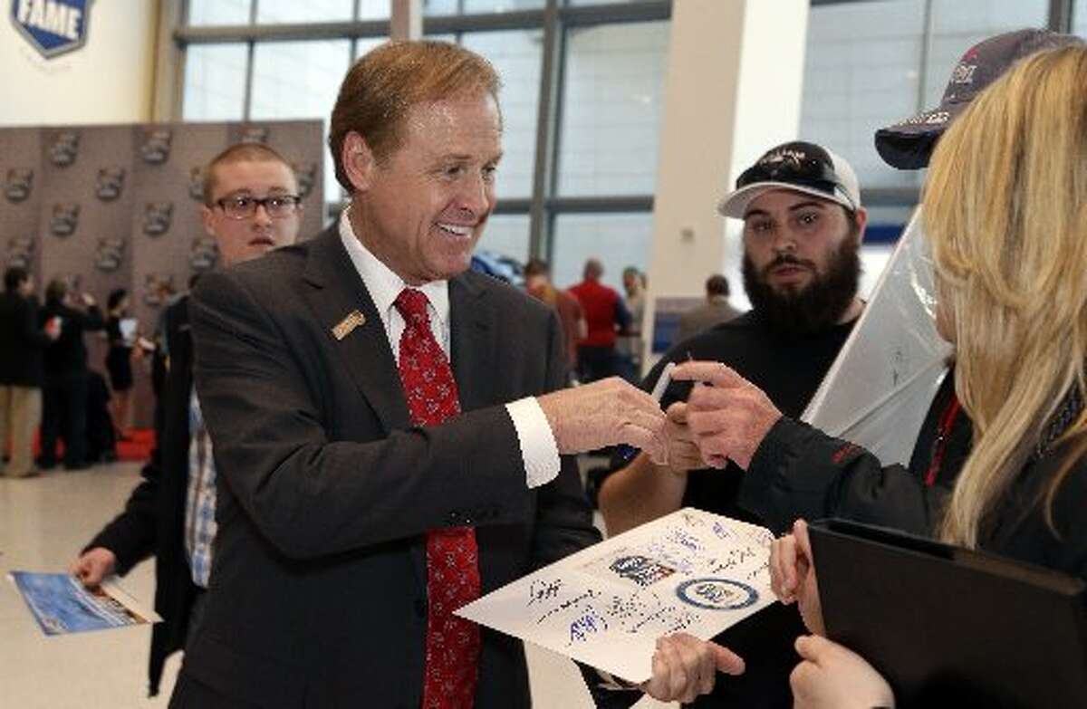 Rusty Wallace signs autographs for fans before making his way into the induction ceremonies for the NASCAR Hall of Fame, Friday, Feb. 8, 2013, in Charlotte, N.C.