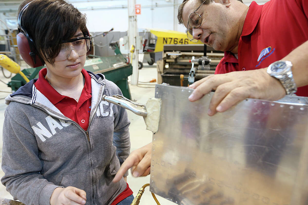 Abigail Gritton, 17, gets help from instructor, Hector Ramos, as she works on a part of an airplane wing during a class at the Alamo Academies for IT and aerospace engineering training, Thursday, April 30, 2015. The class is part of Alamo CollegesÍ Workforce Center for Excellence and is located at St. Philip's College campus on Quintana Road. The program won a national Bellwether Award for innovative community college programs. Gritton is a senior at Judson High School.