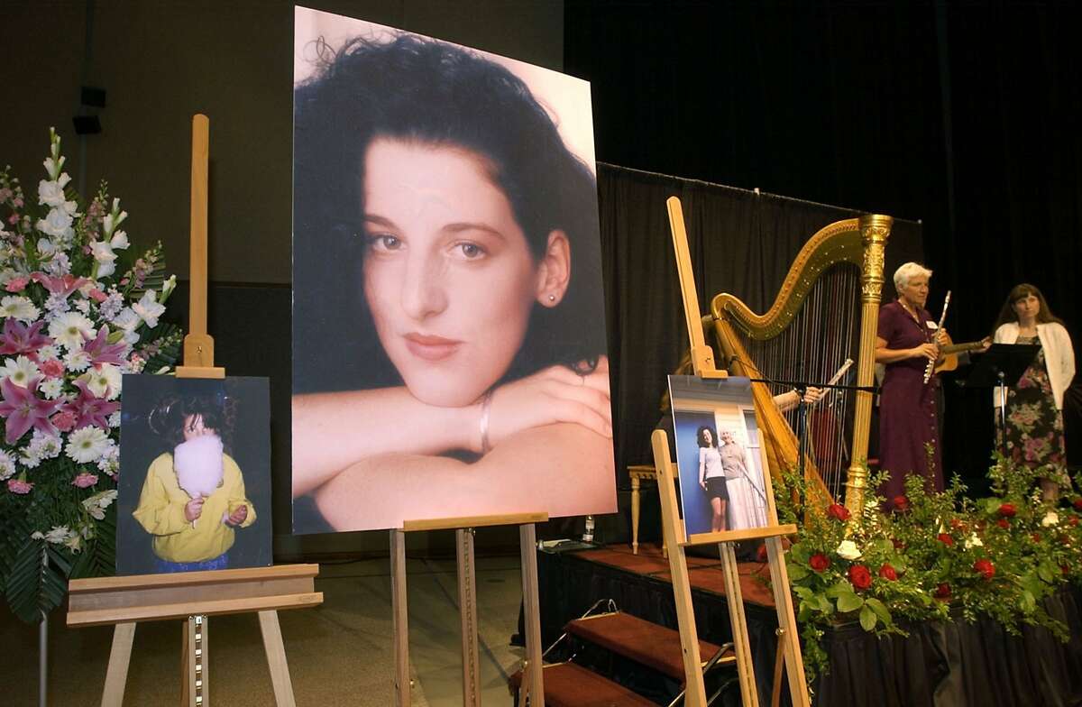 In this May 28, 2002 file photo taken at the Modesto Centre Plaza in Modesto, Calif. photos of Chandra Levy are on display as musicians, right, stand by at the memorial service for Levy.