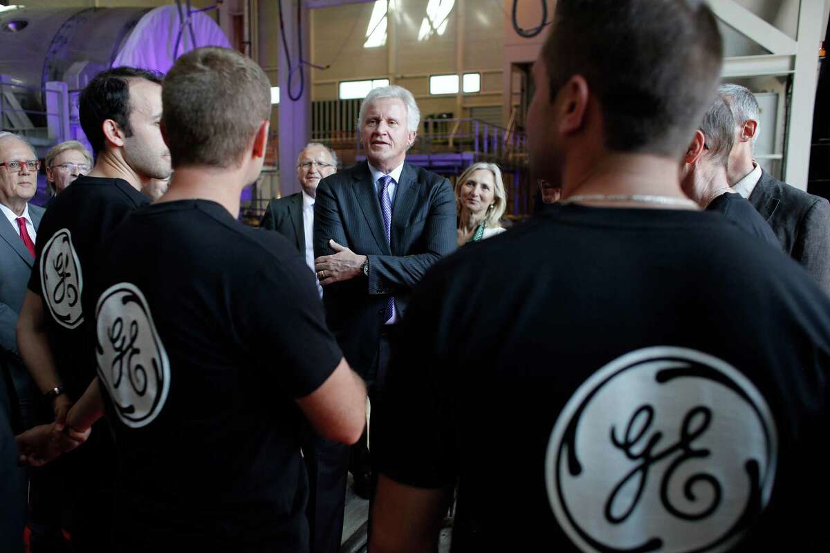 General Electric CEO Jeffrey R. Immelt, center, speaks with workers as he visits the GE plant in Belfort, eastern France.