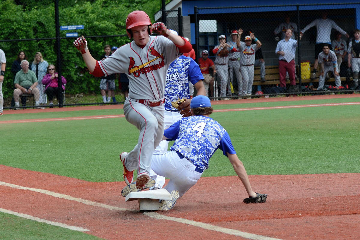 Darien first baseman Conor Davey beats Greenwich's Devin McGrath to first as Darien High School hosts Greenwich High School in Class LL varsity baseball in Darien, CT on June 4, 2015.