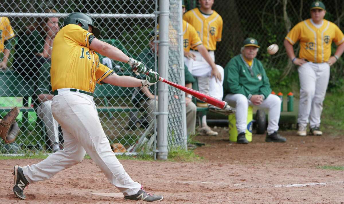 Trinity Catholic's #14 Dillon Daine hits a game winning drive to right field to score Randy Polonia in the bottom of the 11th inning against Portland in a Class S baseball game in Stamford, Conn. on Thursday, June 4, 2015.