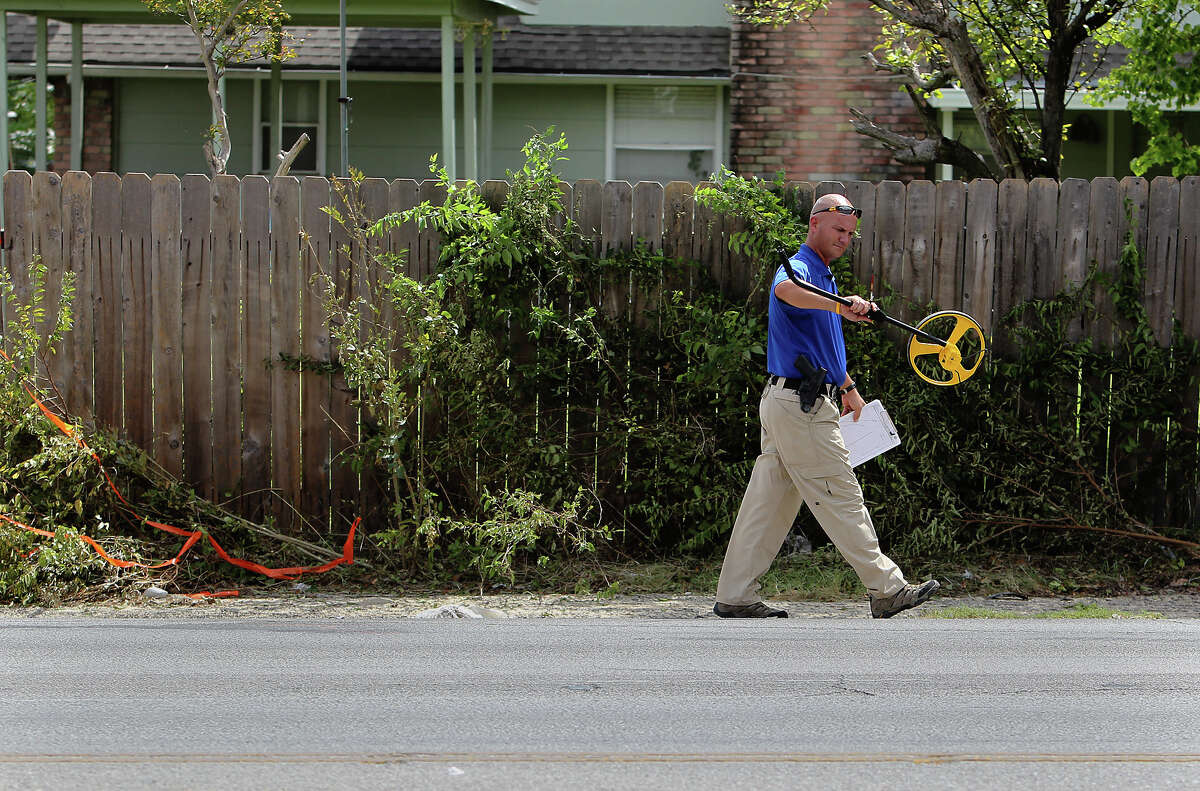 An investigator works at the scene of an accident in which bicylist Devan Coulter Smith was killed in September 2012 on West Avenue north of Silver Sands Drive.