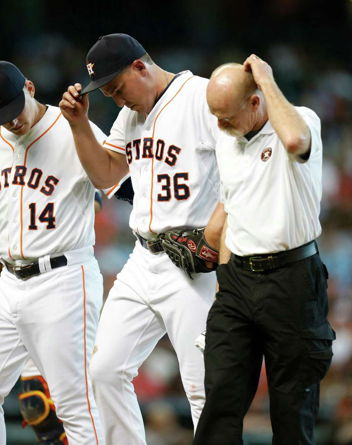 Reliever Will Harris is assisted after getting hit by a piece of Everth Cabrera's bat during a scoreless seventh inning against the Orioles that dropped Harris' ERA to 0.34.