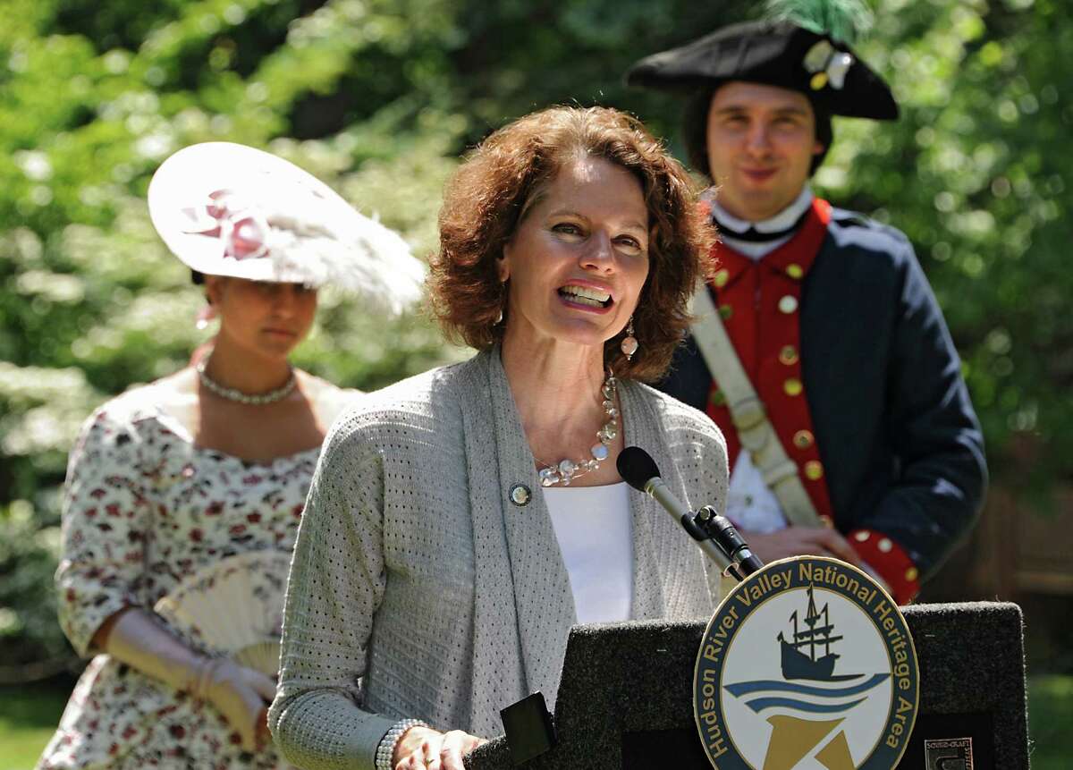 New York State Assemblymember Patricia Fahy speaks during a press conference announcing seven National Heritage Area Heritage Development Grants to historical and cultural institutions in the upper Hudson Valley at the Ten Broeck Mansion gardens on Friday, June 5, 2015 in Albany, N.Y. Standing in the background are living history reenactors Lisa Nunez and Chad Johnson of New Windsor Cantonment State Historic Site. (Lori Van Buren / Times Union)