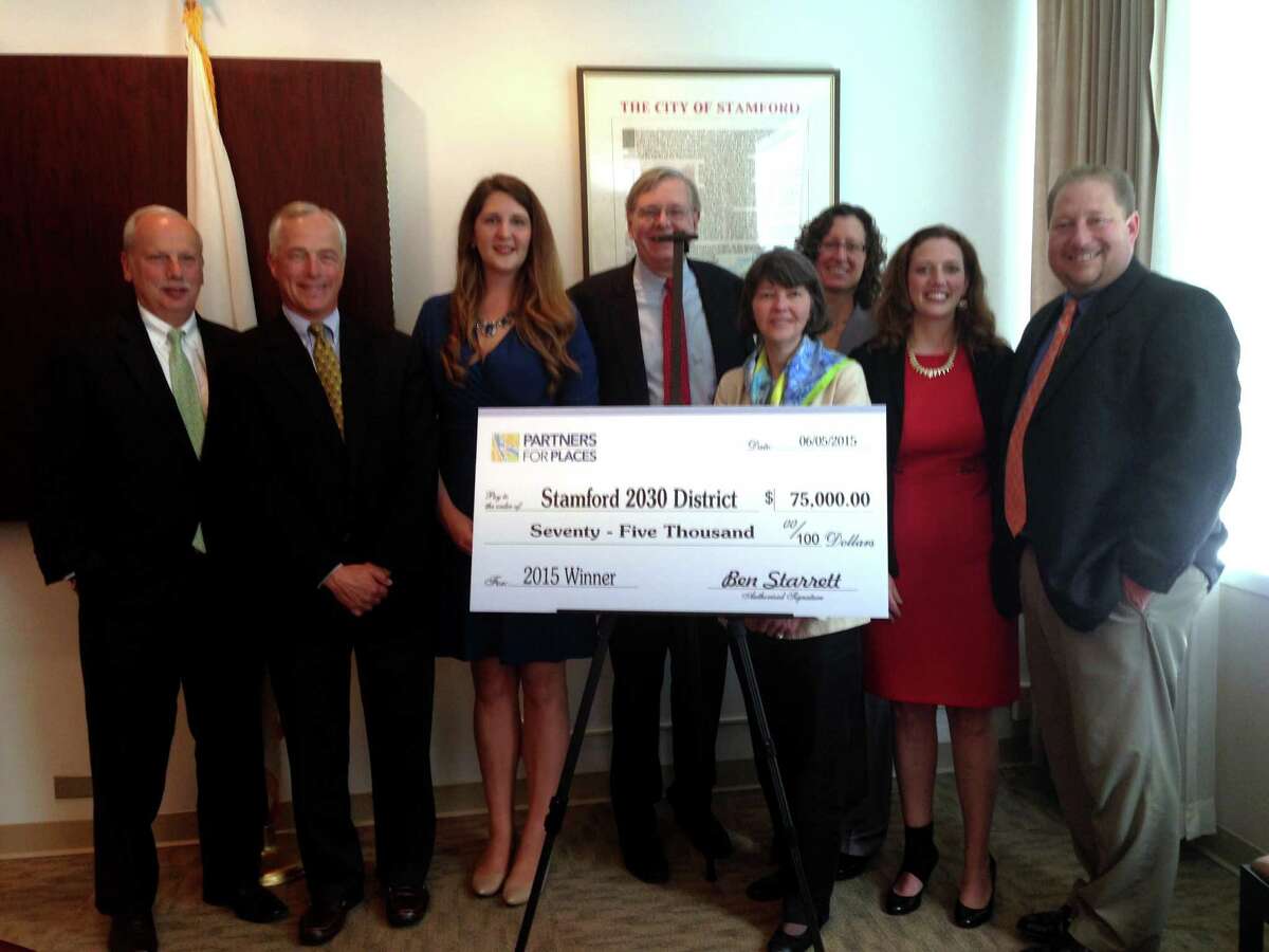 The Stamford 2030 District is awarded a grant from the Funders' Network for Smart Growth and Livable Communities. From left to right: Rey Giallongo, CEO of the First County Bank, Hank Ashforth, of The Ashforth Company, Megan Saunders, executive director of the Stamford 2030 District, Mayor David Martin, Anne Wallace, director of programs at the Funders' Network, Michelle Knapik, president of the Emily Hall Tremaine Foundation, Andrea Pinabell, vice president of sustainability for Starwood Hotels and Resorts, and Thomas Madden, the city's economic development director.