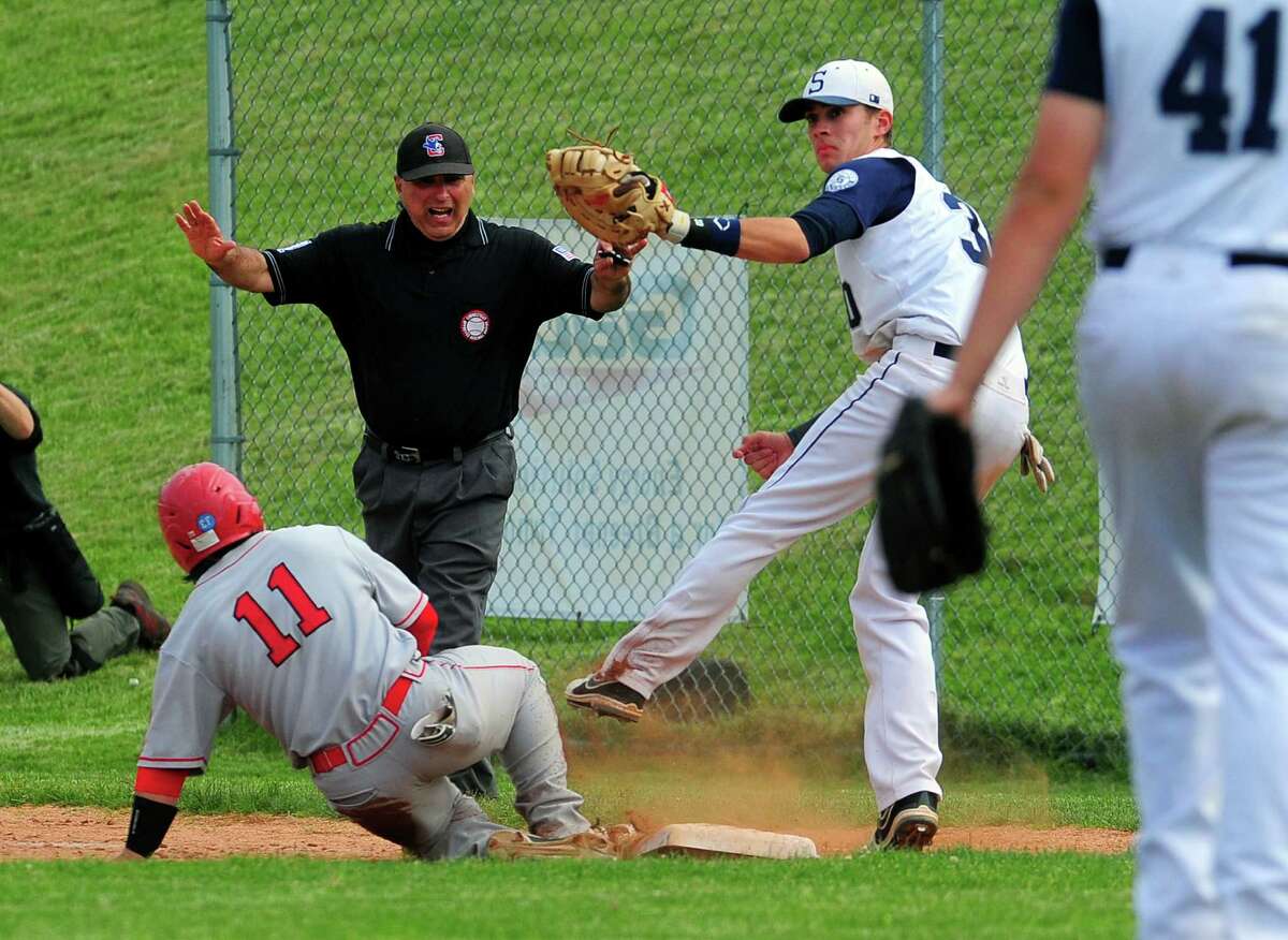 Greenwich's Marco Pastore slides back to first as Staple's Ross Poulley attempts to pick him off, during Class LL baseball quarterfinals action in Westport, Conn., on Friday June 5, 2015.