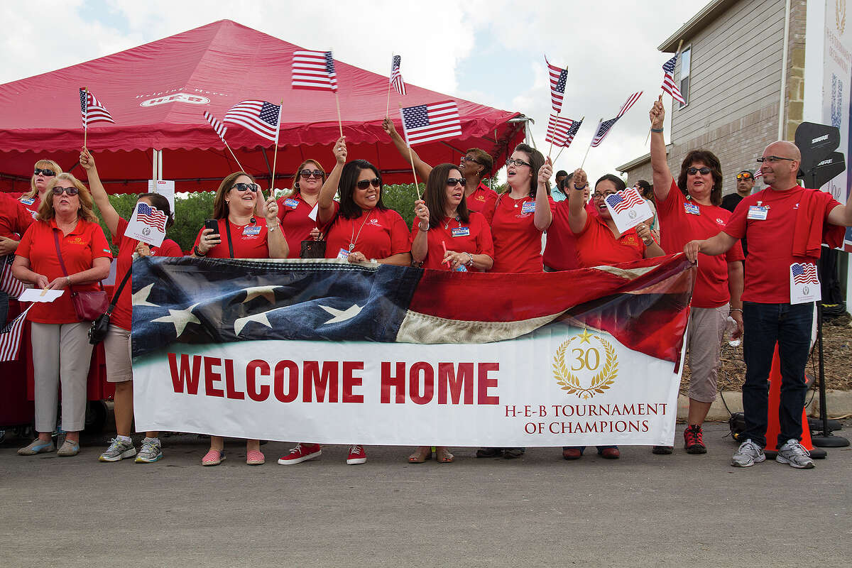 HEB partners line up to welcome the Range and Robinson families who are gifted a new mortgage-free, fully funished home as part of the H-E-B Tournament of Champions program partnered with Operation Finally Home and PulteGroup, Friday, June 5, 2015 in the Champions Park neighborhood. The military families were chosen by Operation Finally Home, a national nonprofit organization dedicated to building homes for wounded, ill or injured veteran and their families.